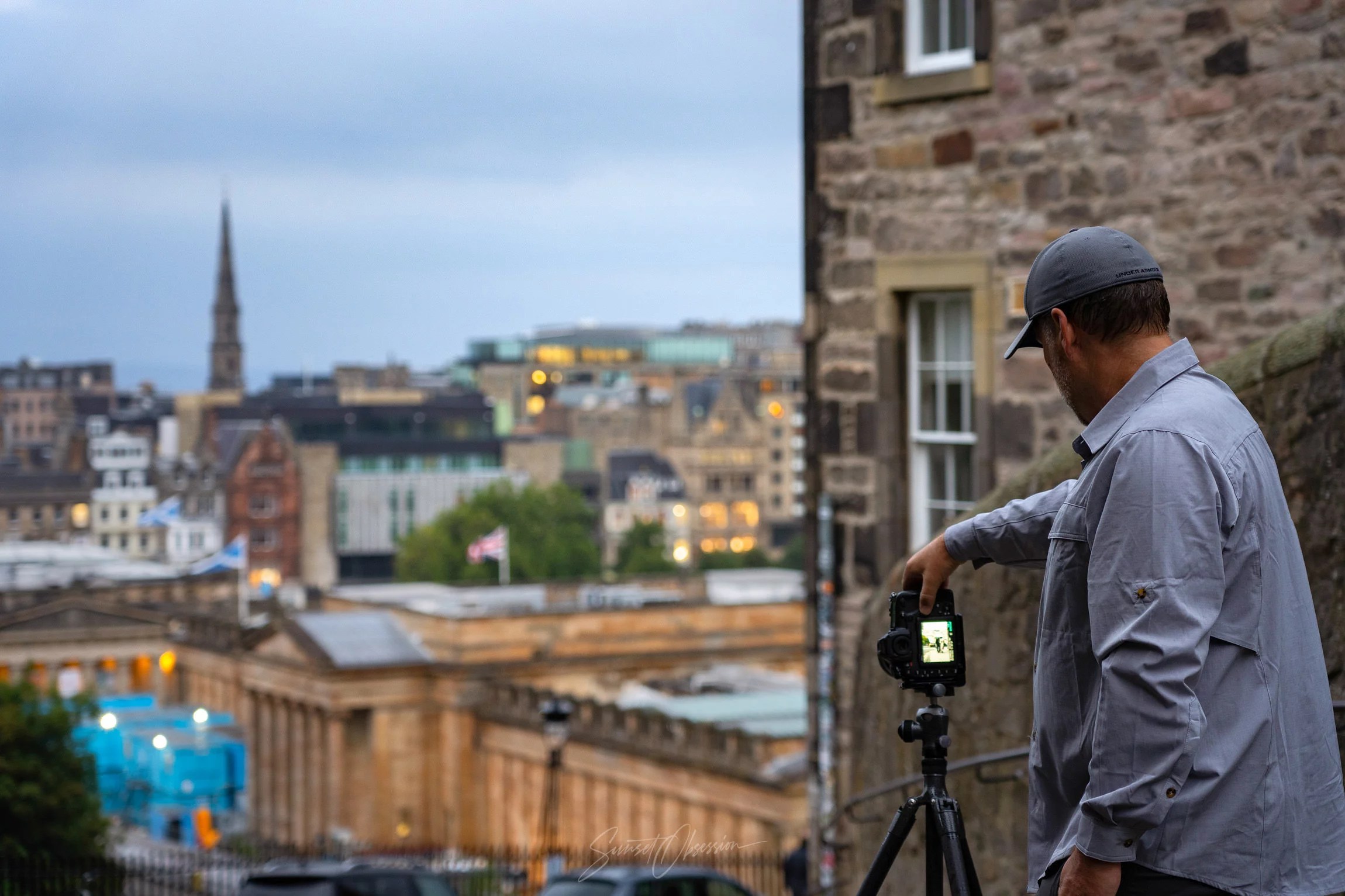 Photographer taking an image of Edinburgh during the blue hour