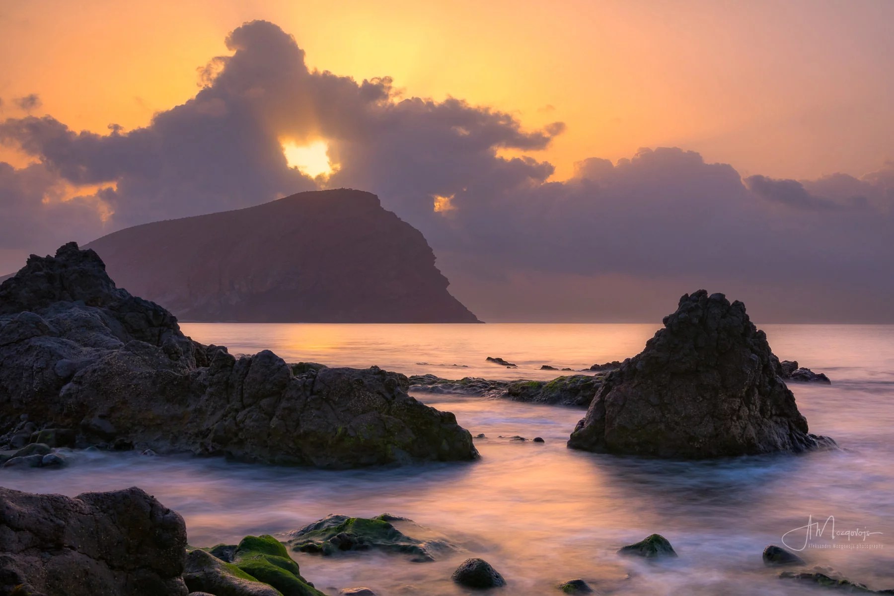 Sunrise behind the Red Mountain at La Tejita beach, Tenerife